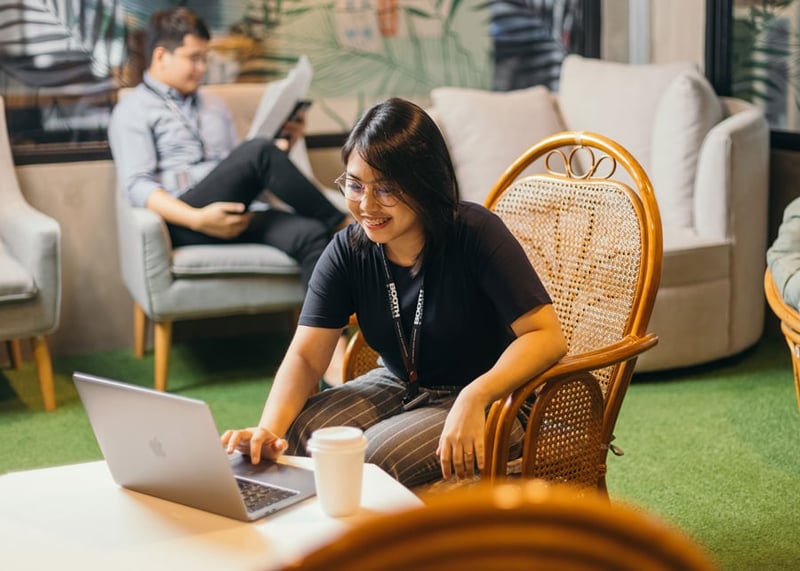 Booth employee working on laptop in common-area